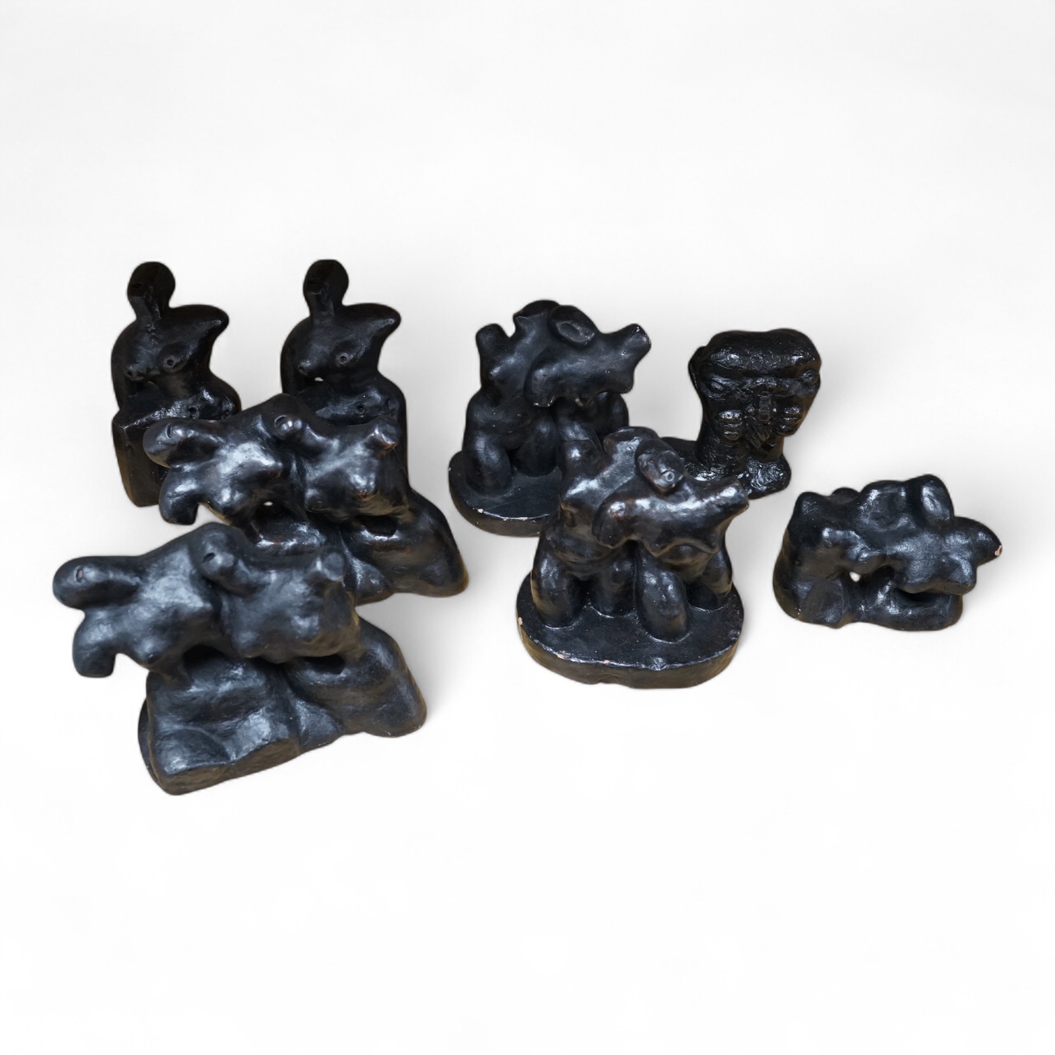 Three pairs of small black figural abstract sculptures, together with two similar sculptures. (8). Tallest 15cm high